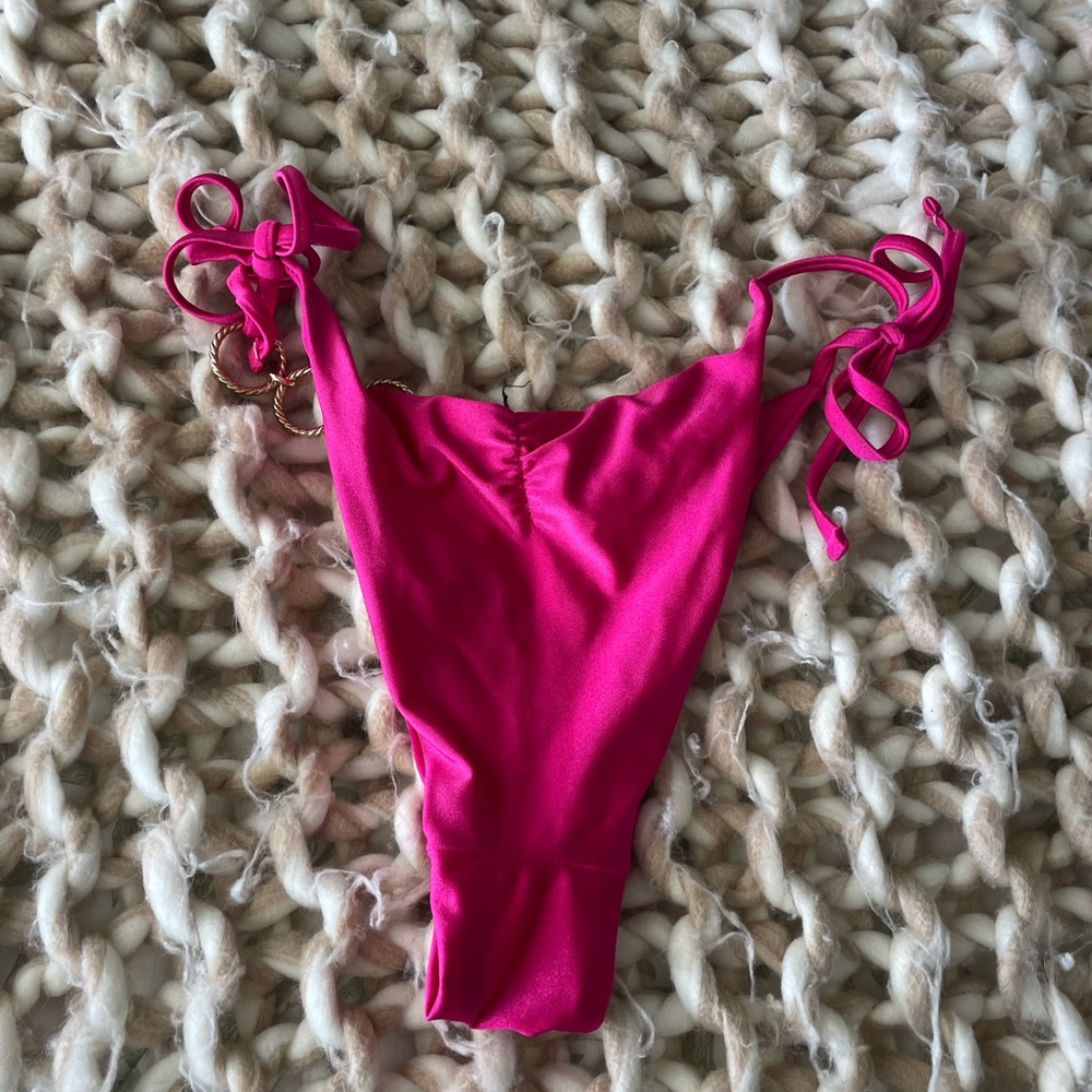 Gold ringed swimsuit tie at side
